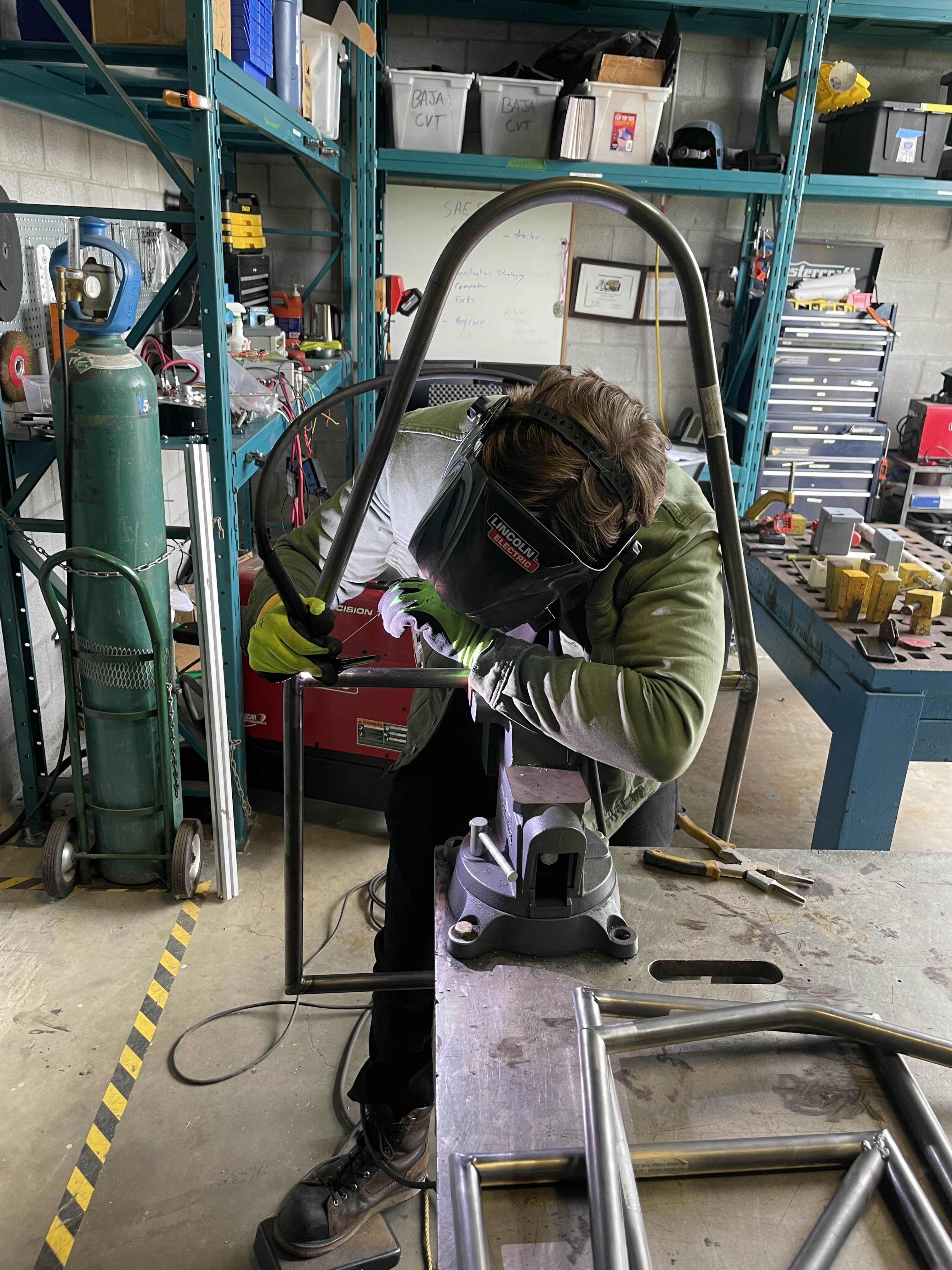 Conestoga students assembling the Formula Electric chassis in the Cambridge shop